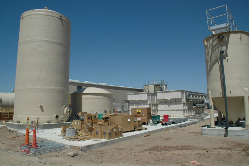 Construction of Endeavour's current groundwater treatment system, which began operating in 2012.  From left to right: sludge storage tank, clarified water tank, two dissolved air flotation tanks (DAFs), and one sand filter.  An influent equalization tank is located behind the DAFs.