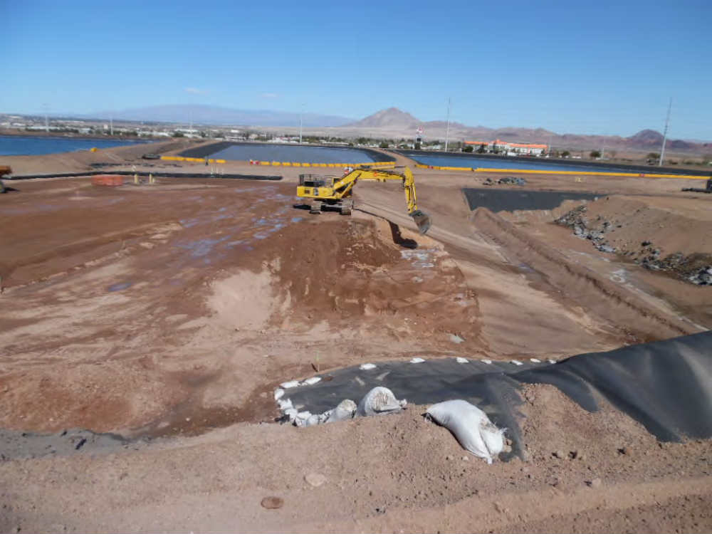 2016 - TIMET S-18 Landfill installation operations showing a typical cell being constructed.  Process water retention  ponds (also TIMET) are in the background.
