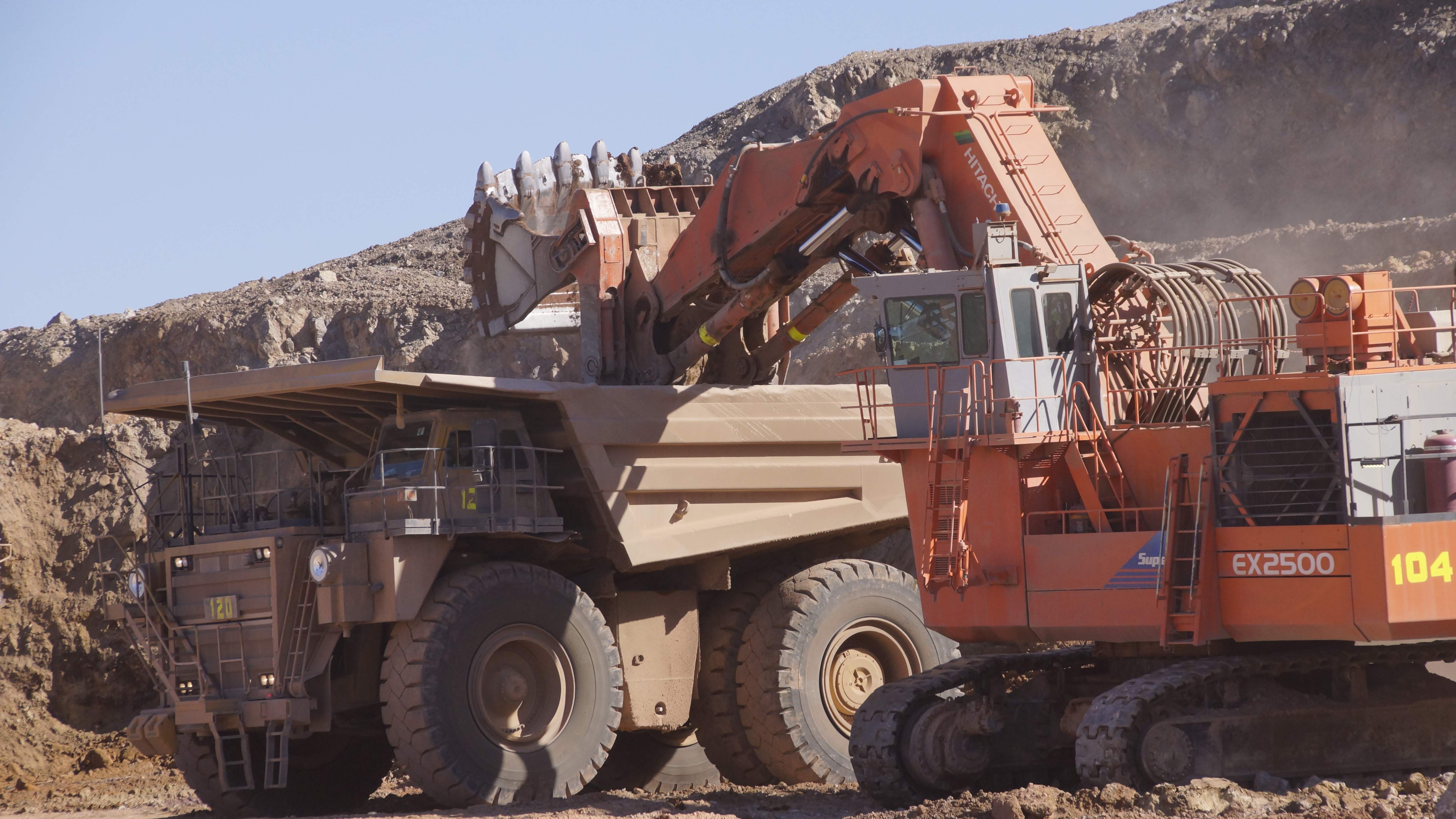 Haul truck being loaded by tracked shovel.