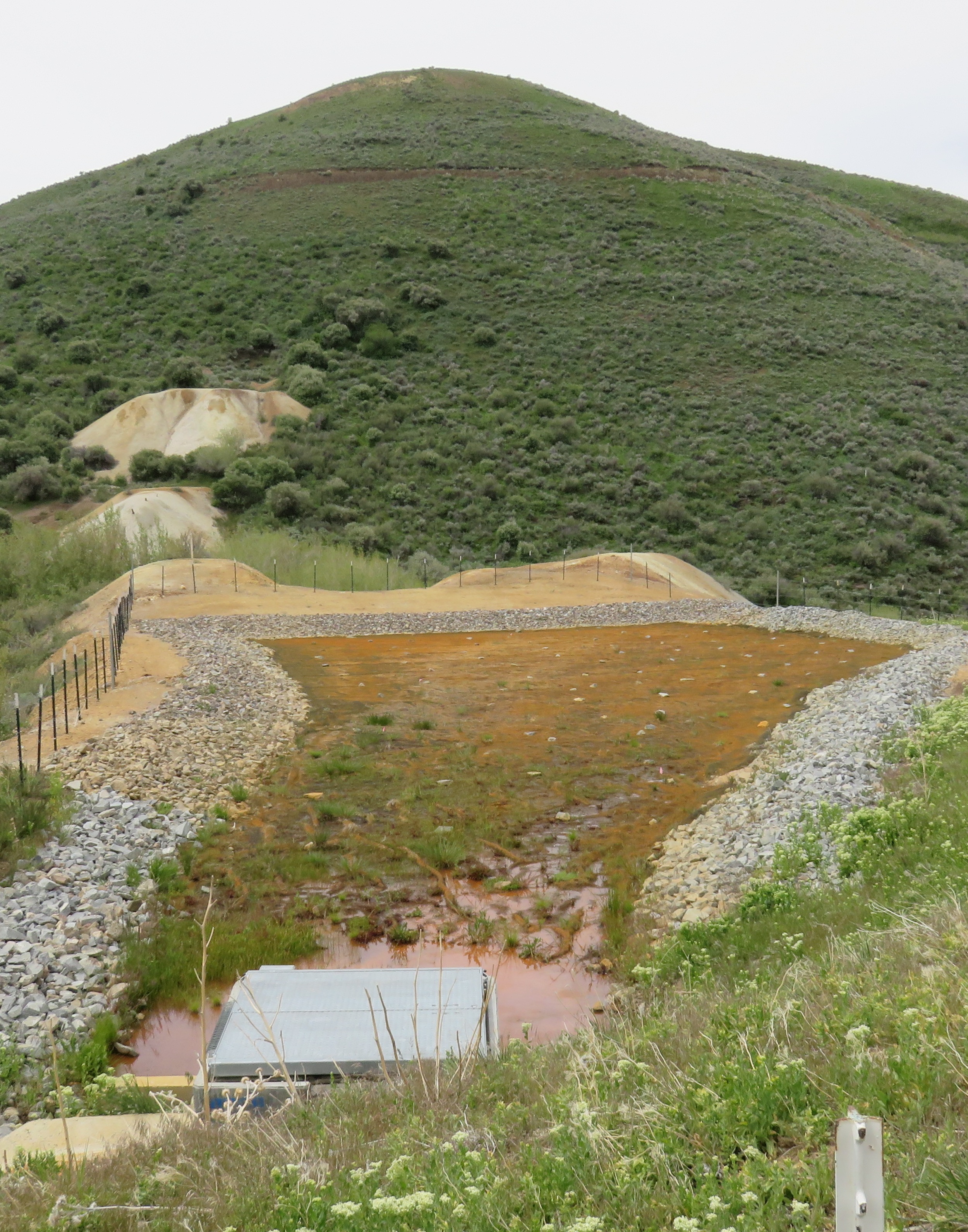 View south across the adit drainpipe and long-term passive treatment system installed to reduce arsenic levels in the mine drainage at Birthday Mine, Humboldt County, Nevada.